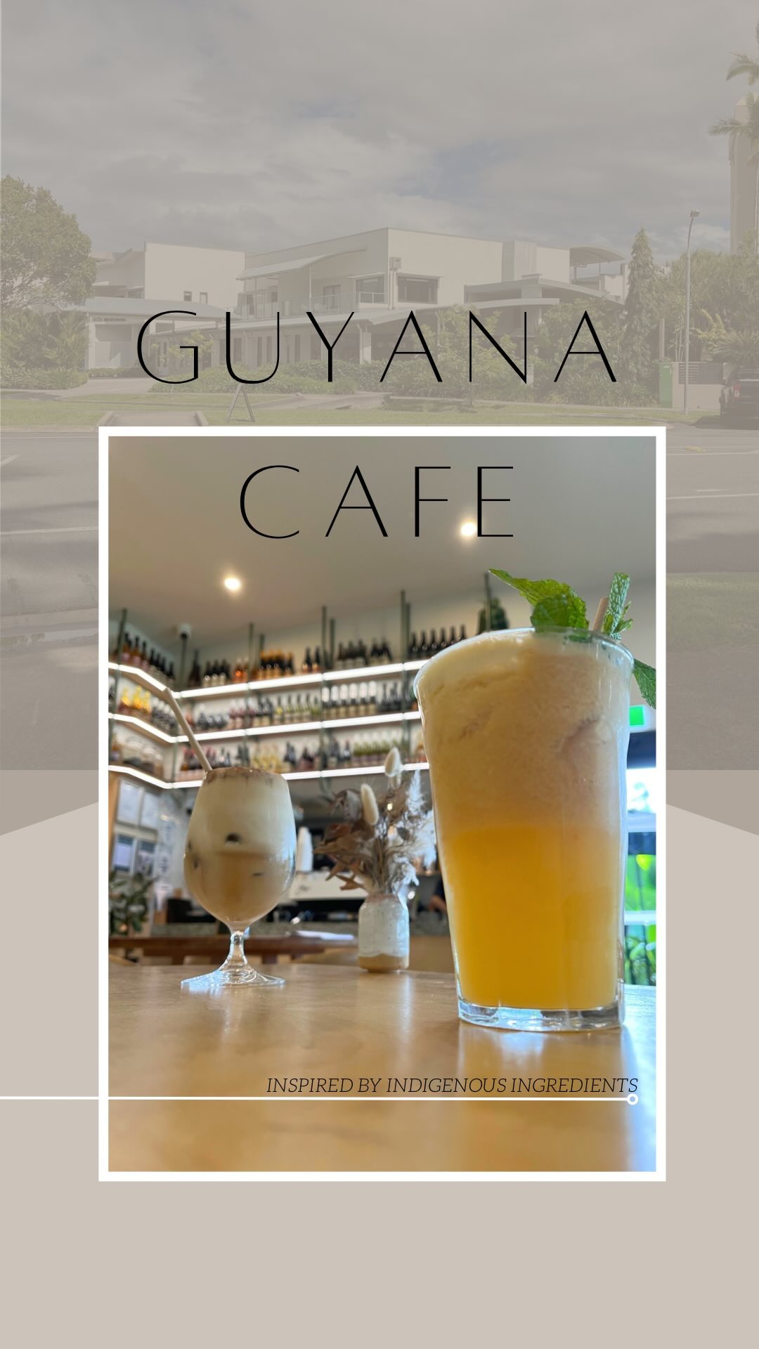 An iced coffee in a stemmed glass and a tall orange juice with mint sitting on a timber table inside Guyala Cafe.