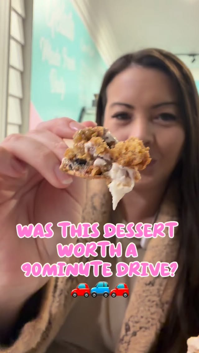 Zen holding up a piece of cookie pie on a wooden spoon in front of the camera at Burleigh Gelato Co.