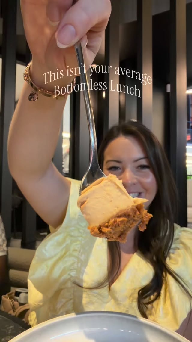 Zen holding up a spoonful of Biscoff cheesecake in front of Dark Shepherd's dark wood slatted interior, with on-screen text reading 'This isn't your average Bottomless Lunch'.